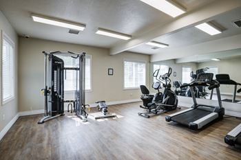 A spacious home gym with a variety of exercise equipment.